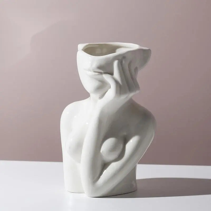 Sculptural human body ceramic vase, perfect for displaying flowers or as a standalone piece.