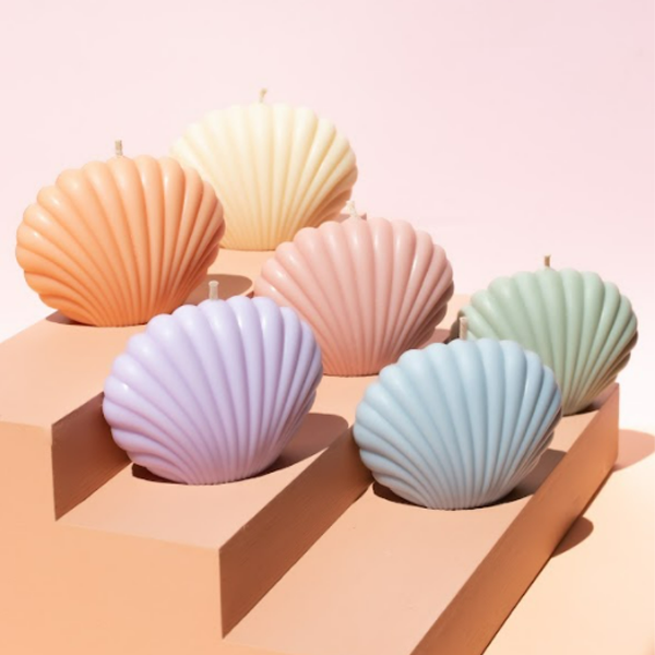 Scented candle in a shell-shaped container, adding a coastal vibe to your space.