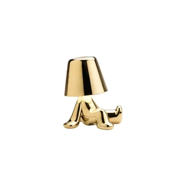 Gold Table lamp designed as a small man figure, creating a cheerful and inviting atmosphere.