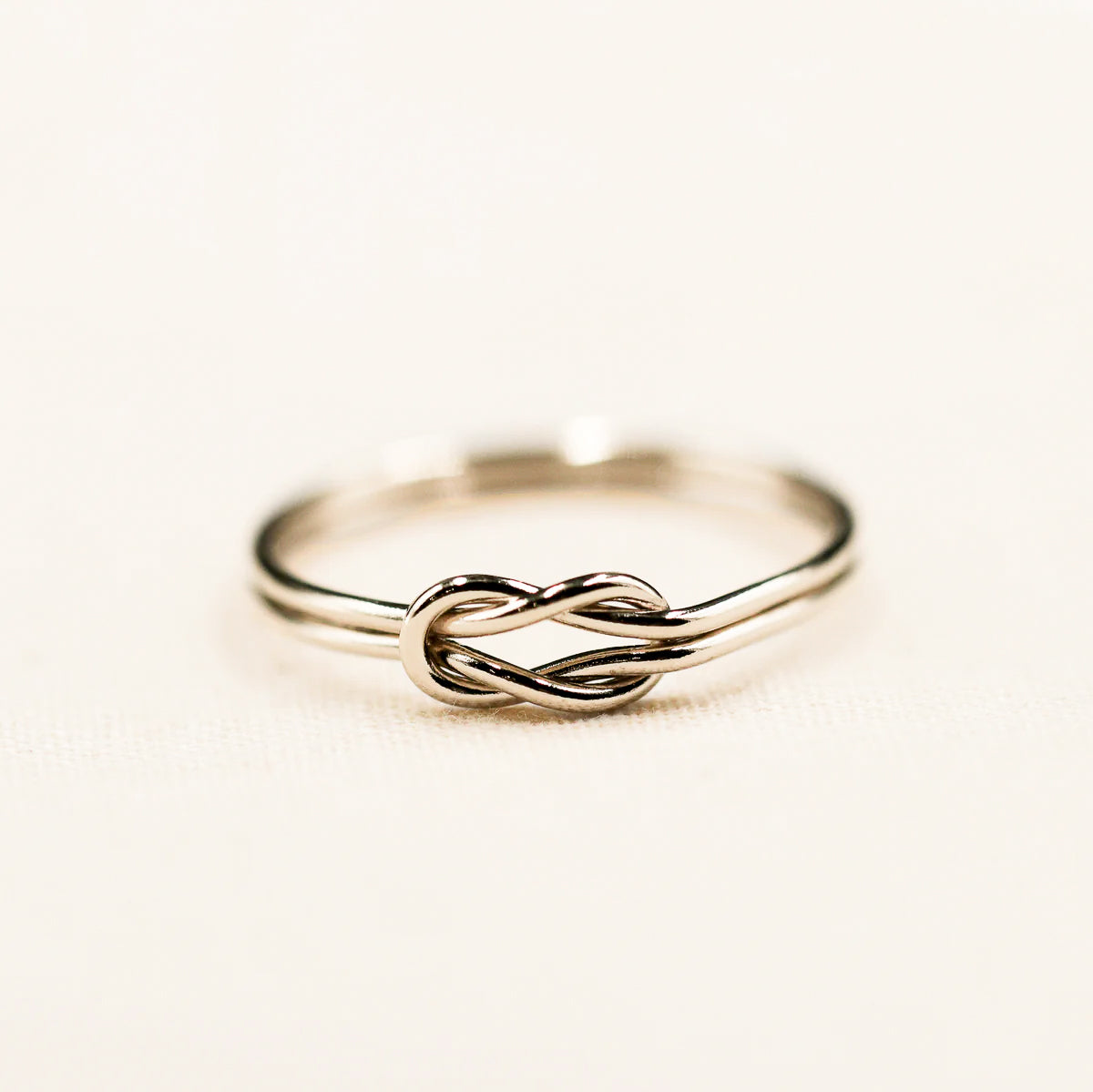 Infinity knot ring, available in both silver and gold, symbolizing infinite love and friendship.