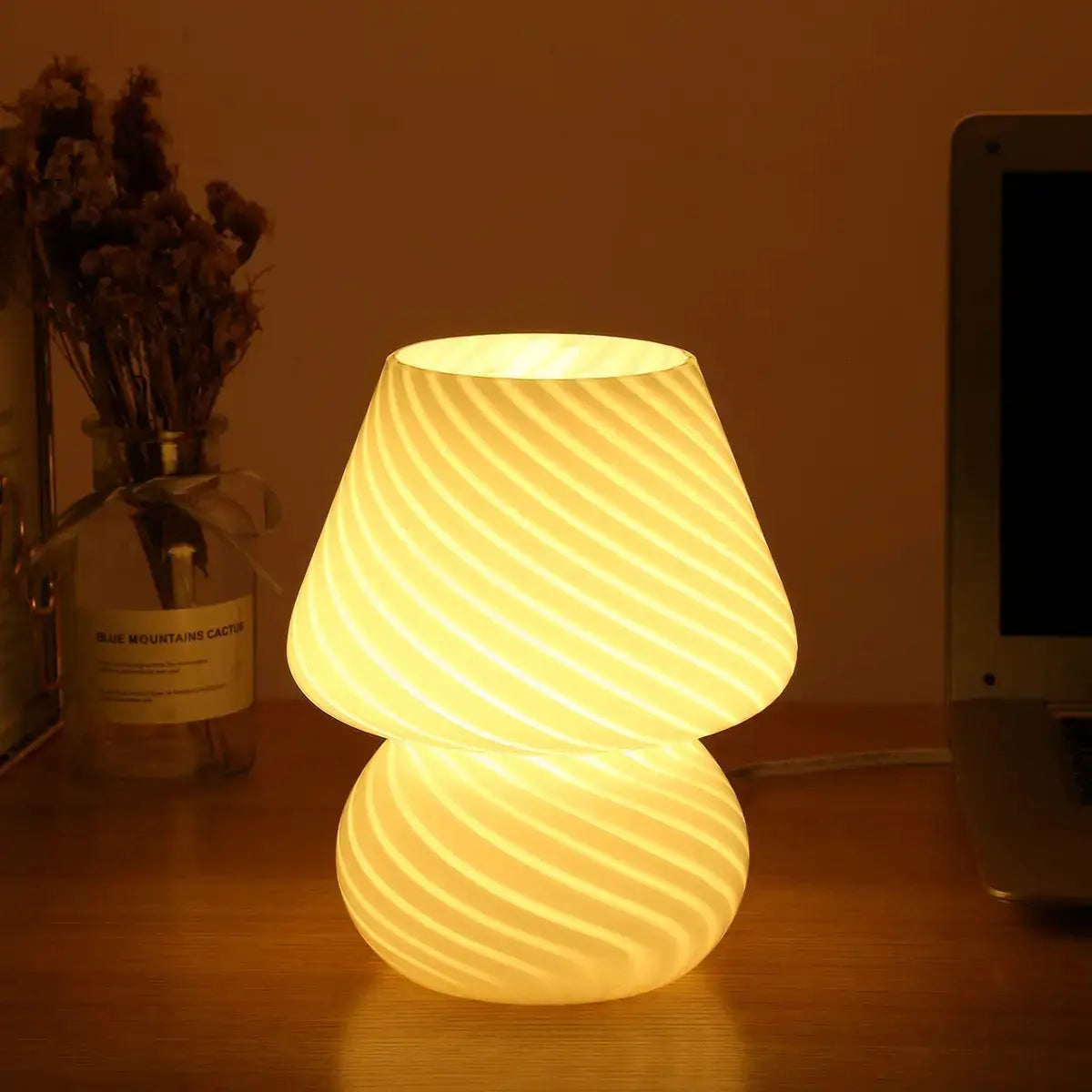 Modern glass bedside lamp, casting a soft and inviting glow.