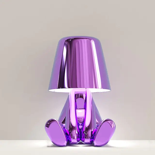 Purple miniature man-shaped LED lamp, a fun and creative lighting option for any room.