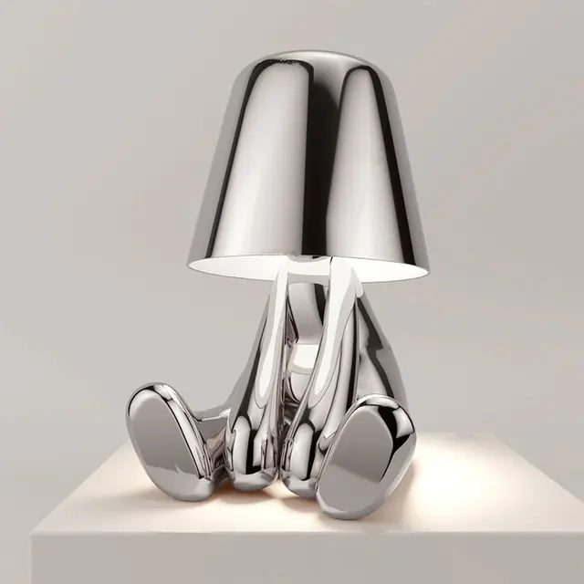 Silver Little man LED table lamp, a whimsical and unique lighting fixture for your home.