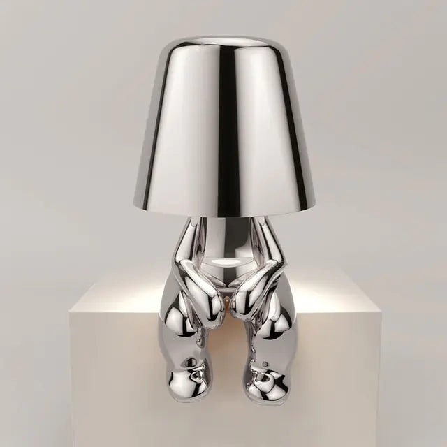 Silver LED table lamp featuring a delightful little man design, perfect for a child's room.